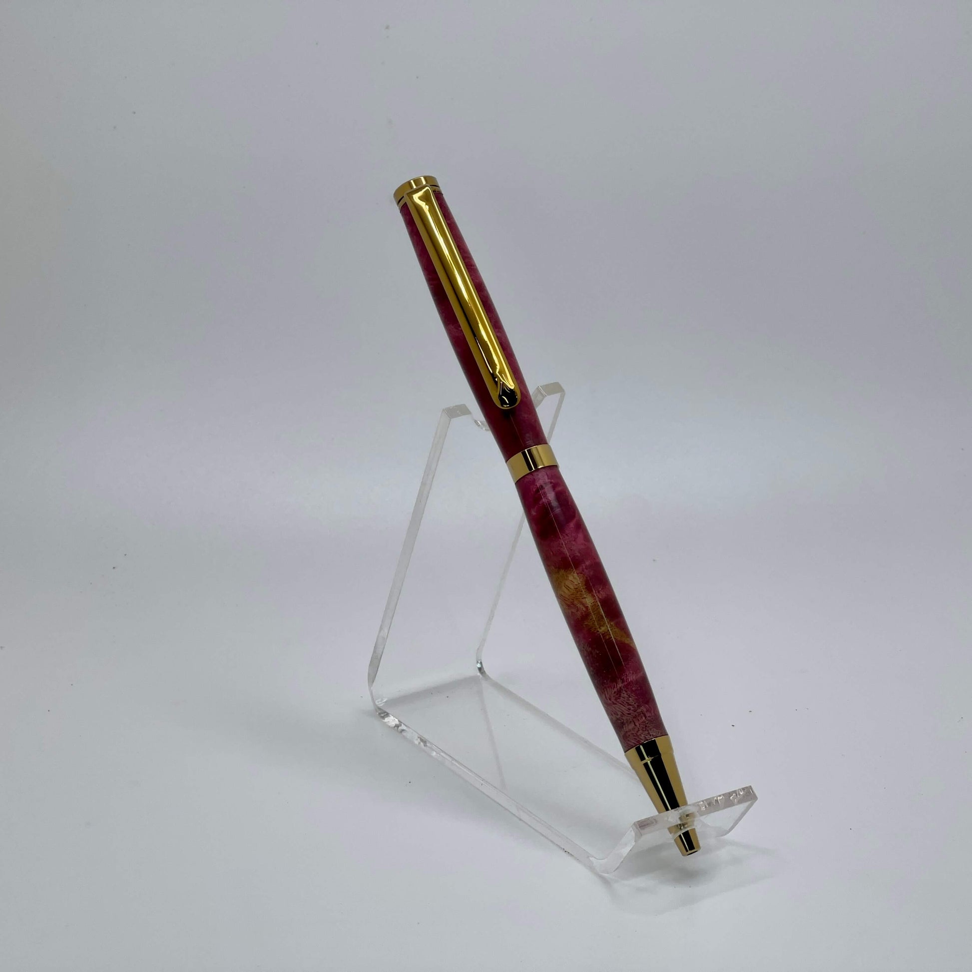 Left side view of handcrafted pen with Box Elder Burl wood dyed magenta