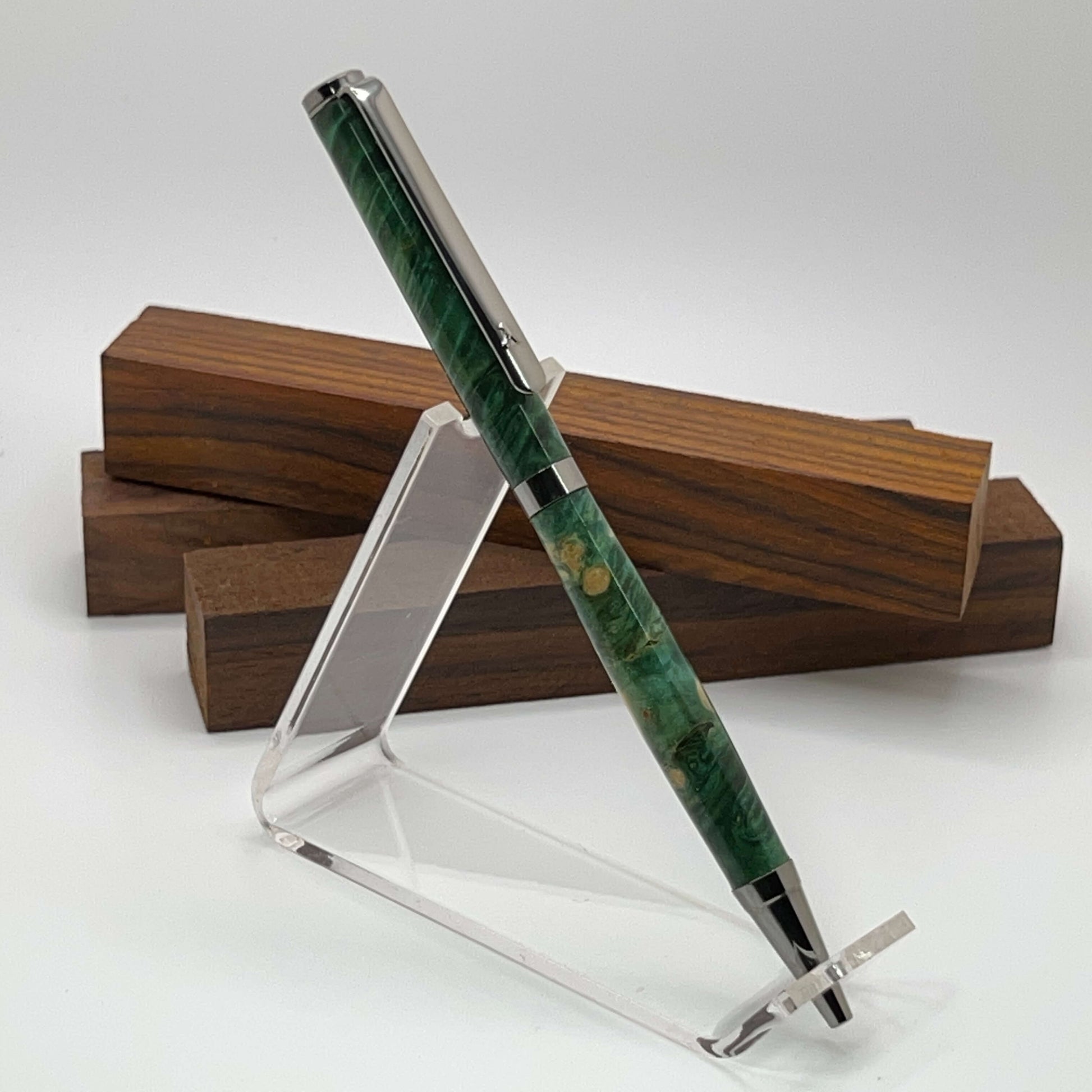 Handcrafted pen with Box Elder Burl wood dyed green and black titanium hardware