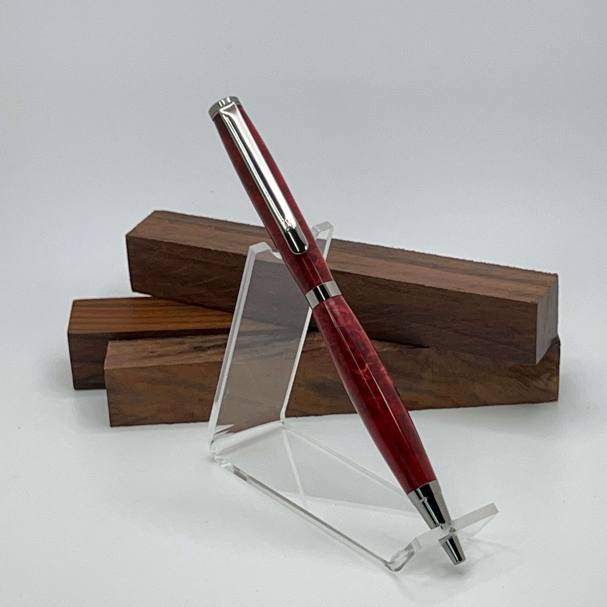 Handcrafted pen with Box Elder Burl wood dyed red and black titanium hardware