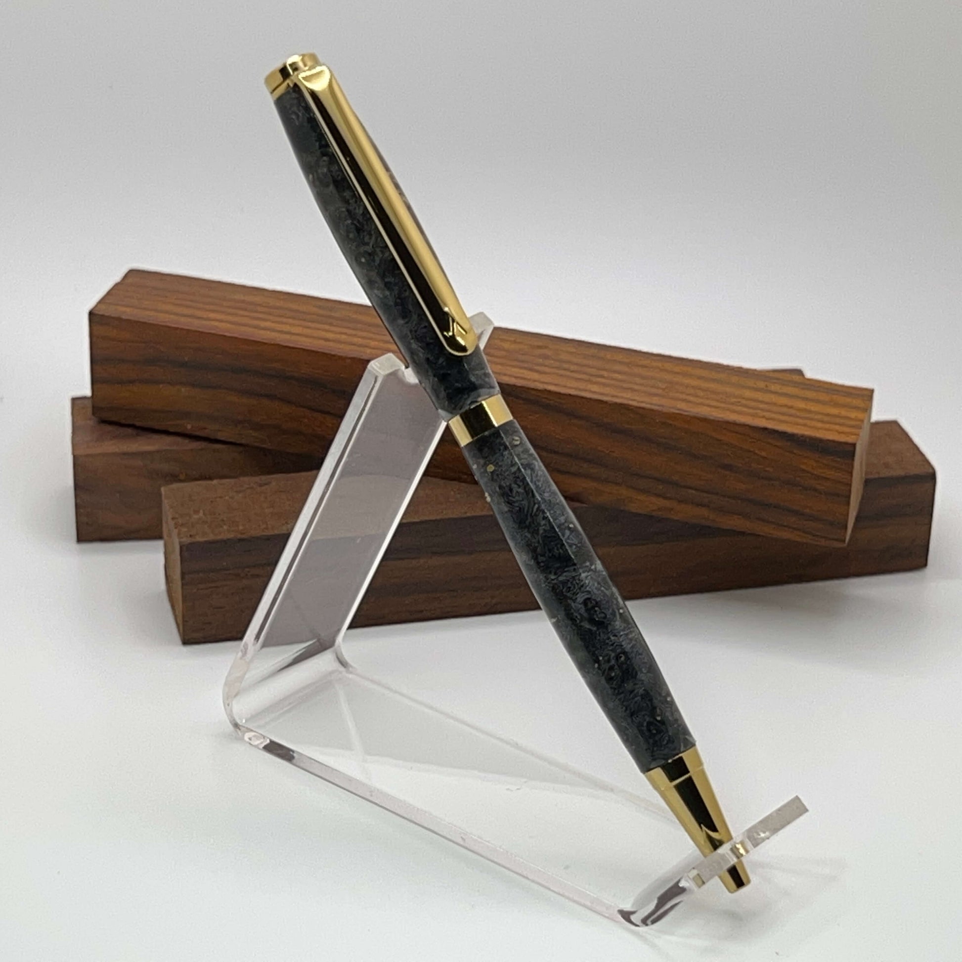 Handcrafted pen with Box Elder Burl wood dyed black and gold titanium hardware