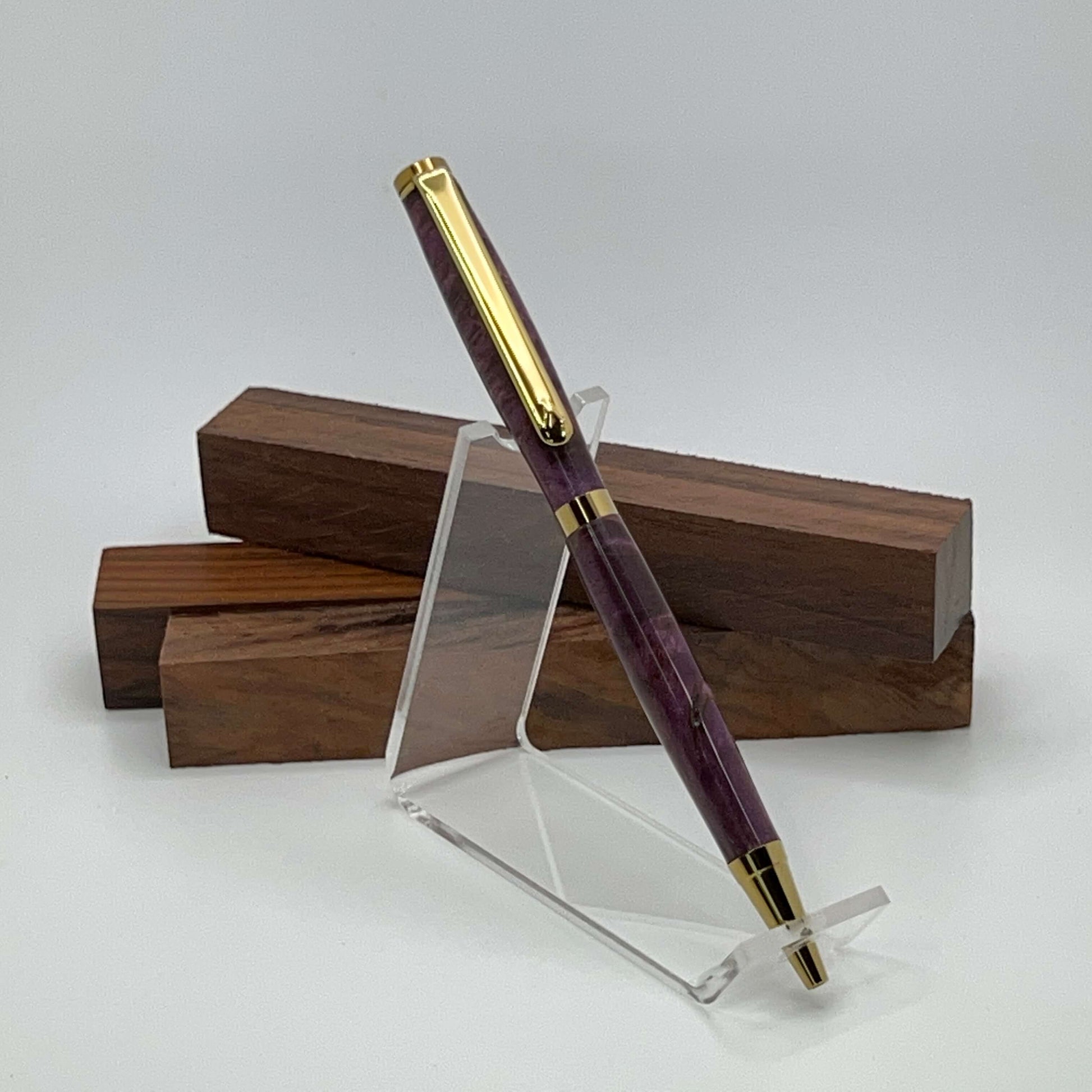 Handcrafted pen with Box Elder Burl wood dyed purple and gold titanium hardware