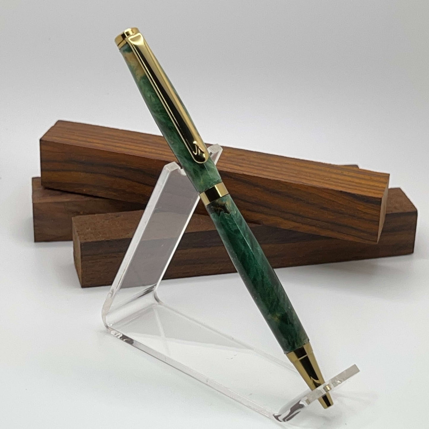 Handcrafted pen with Box Elder Burl wood dyed green and gold titanium hardware