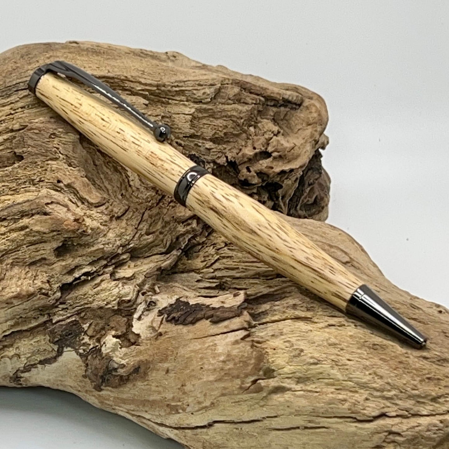 Handcrafted Tamarind Wood pen setting on driftwood