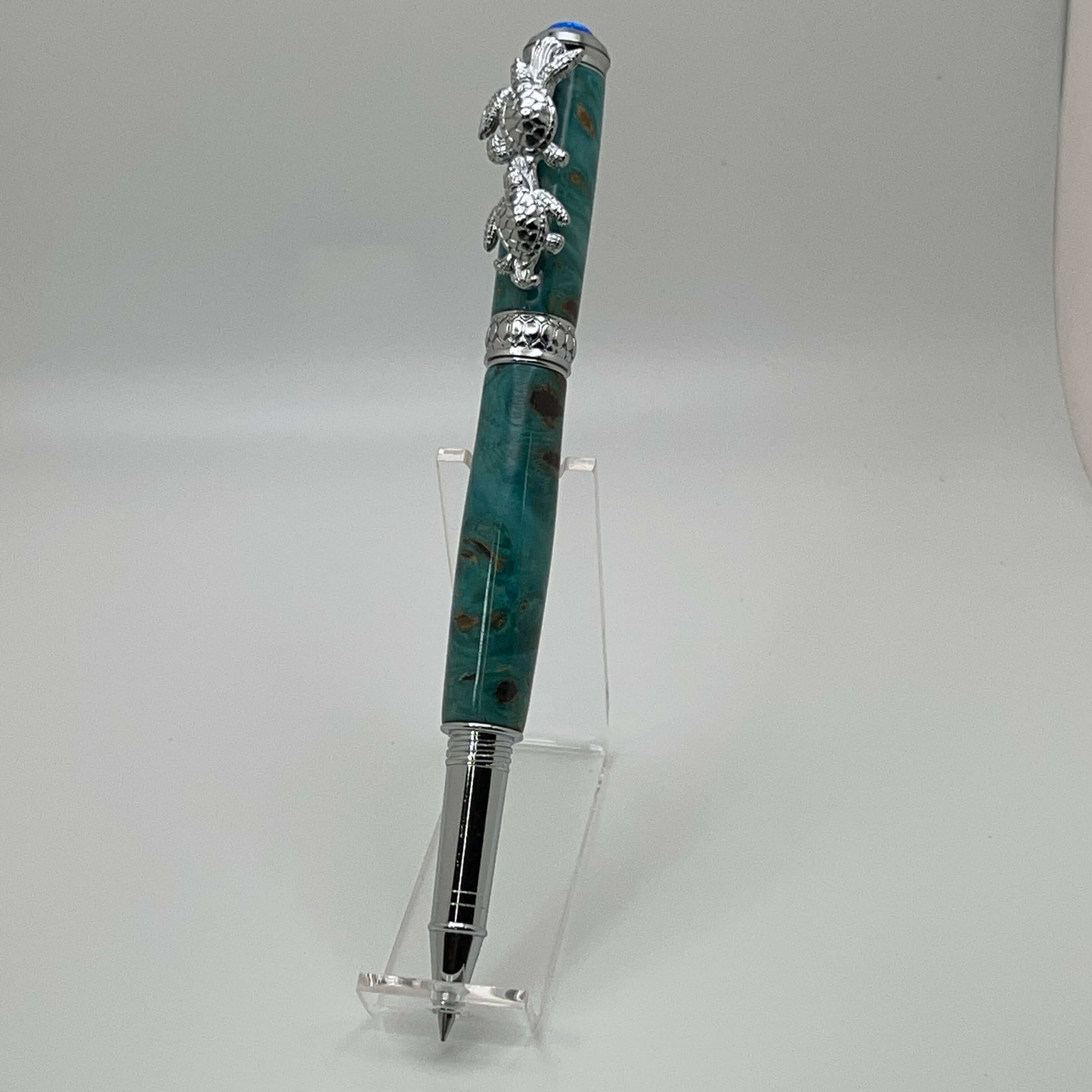 Handcrafted Box elder wood pen dyed turquoise with a beautiful synthetic fire opal on top right side