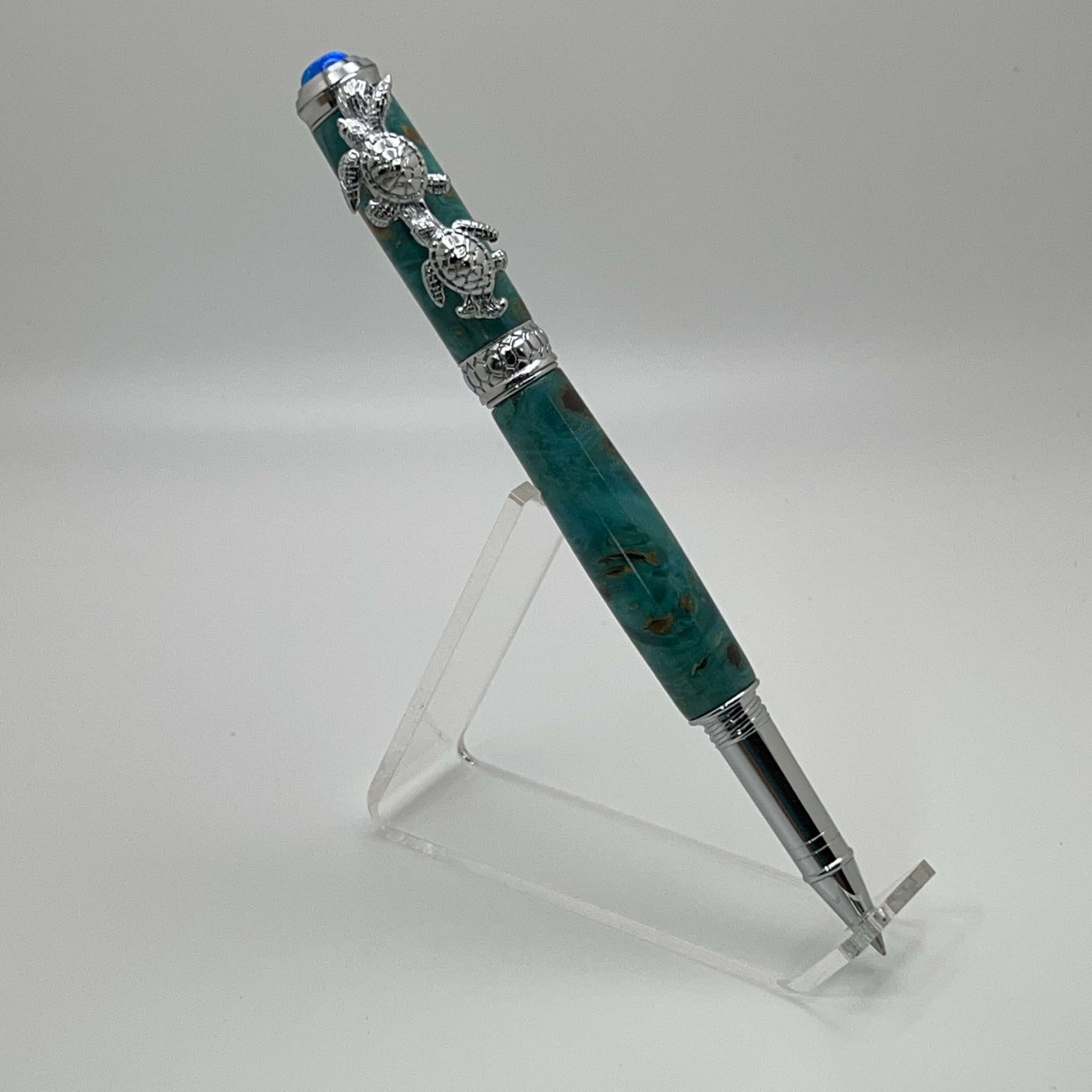 Handcrafted Box elder wood pen dyed turquoise with turtle cap posted on top right side