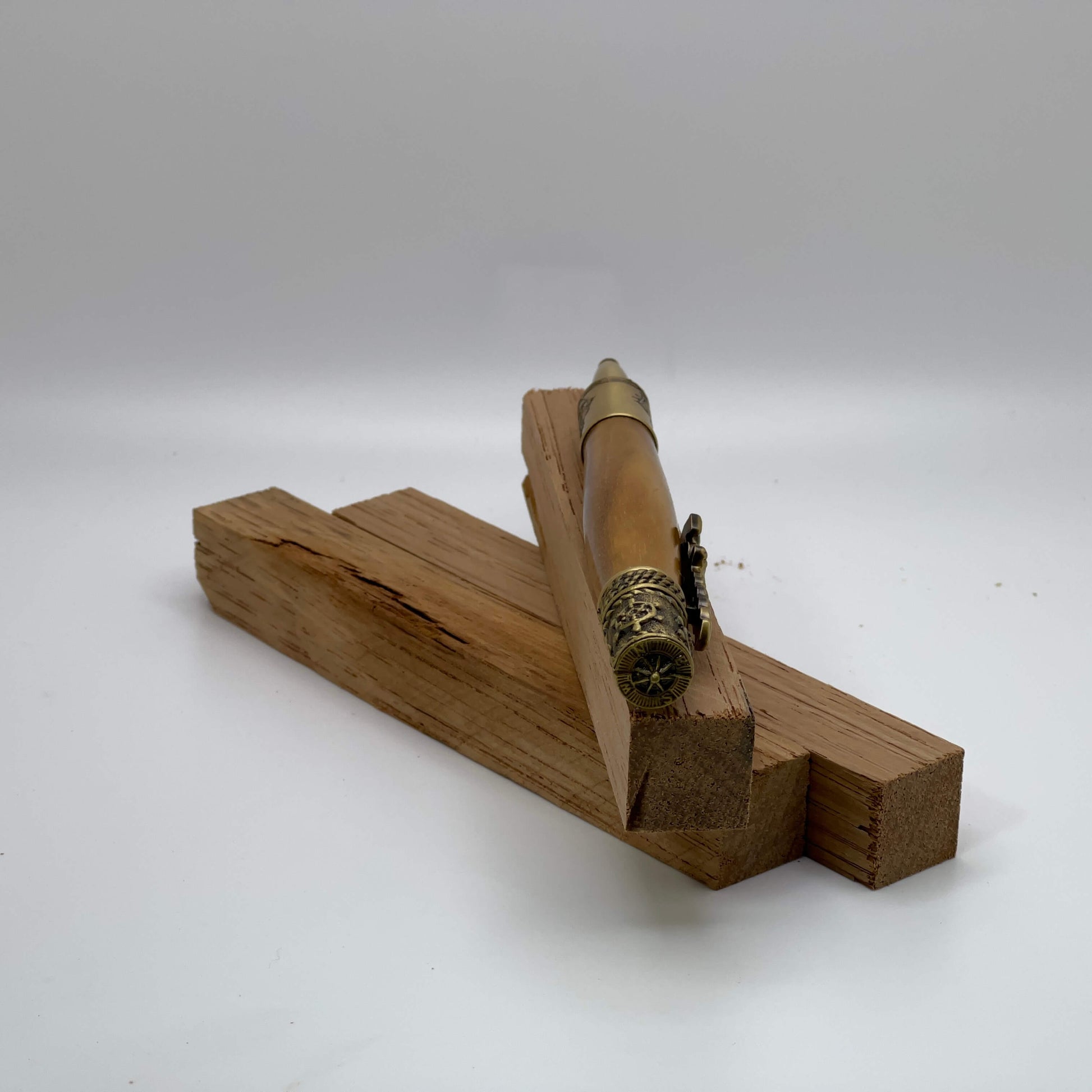 Nautical teak wood twist style ballpoint pen. Features antique brass anchor clip, ships wheel, view of compass. 