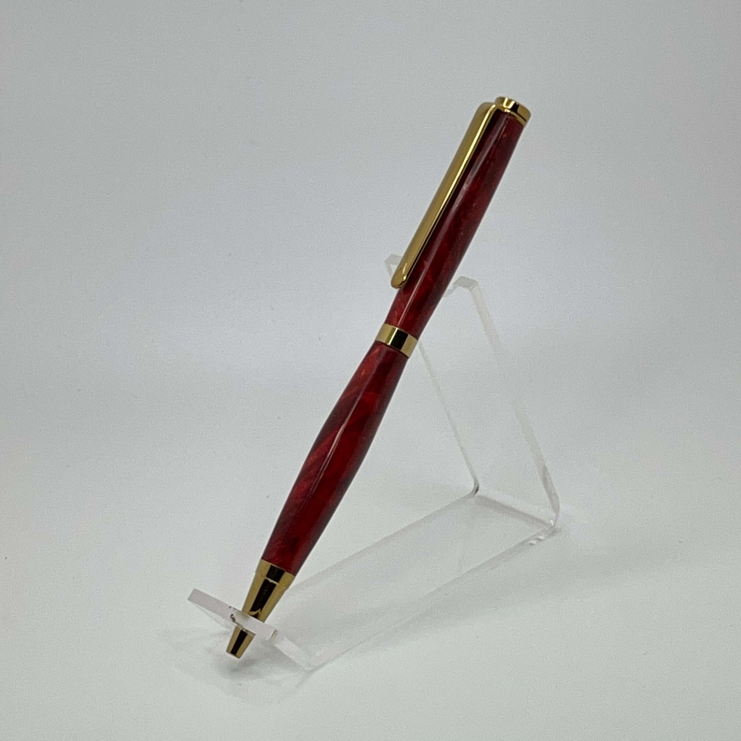 Left side view of handcrafted pen with Box Elder Burl wood dyed red