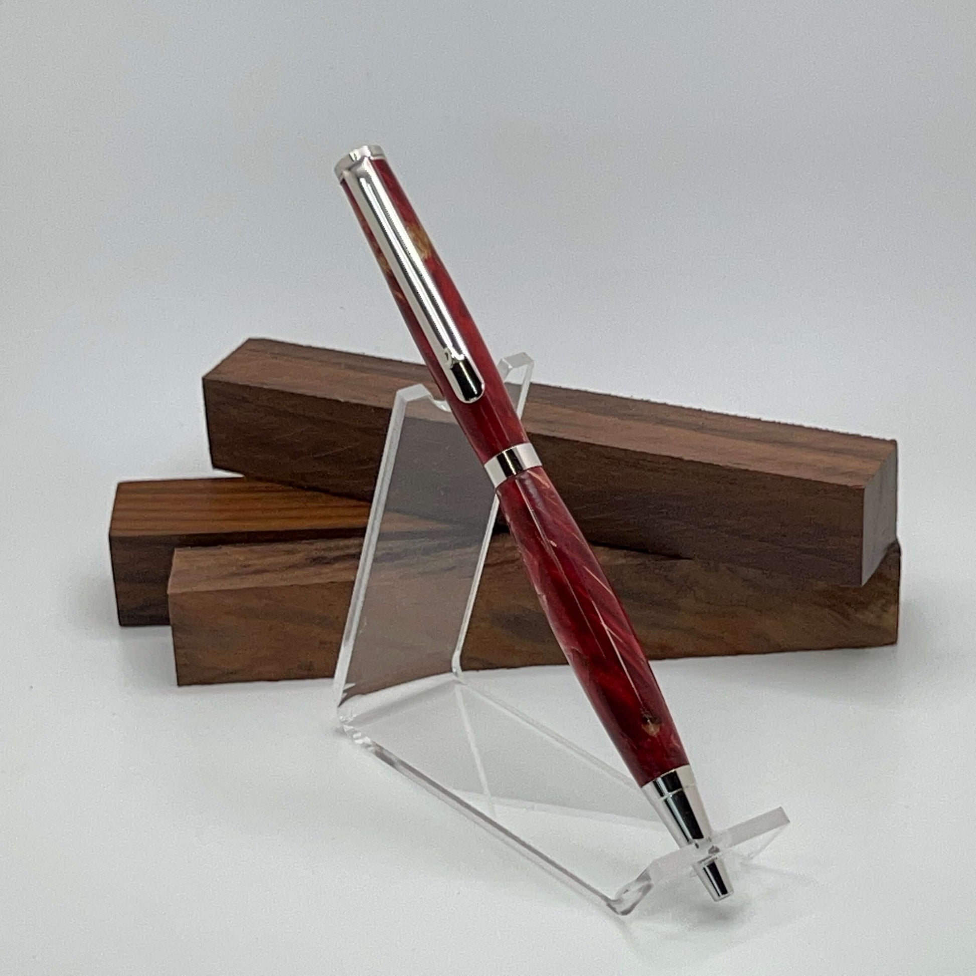 Handcrafted pen with Box Elder Burl wood dyed red and rhodium hardware