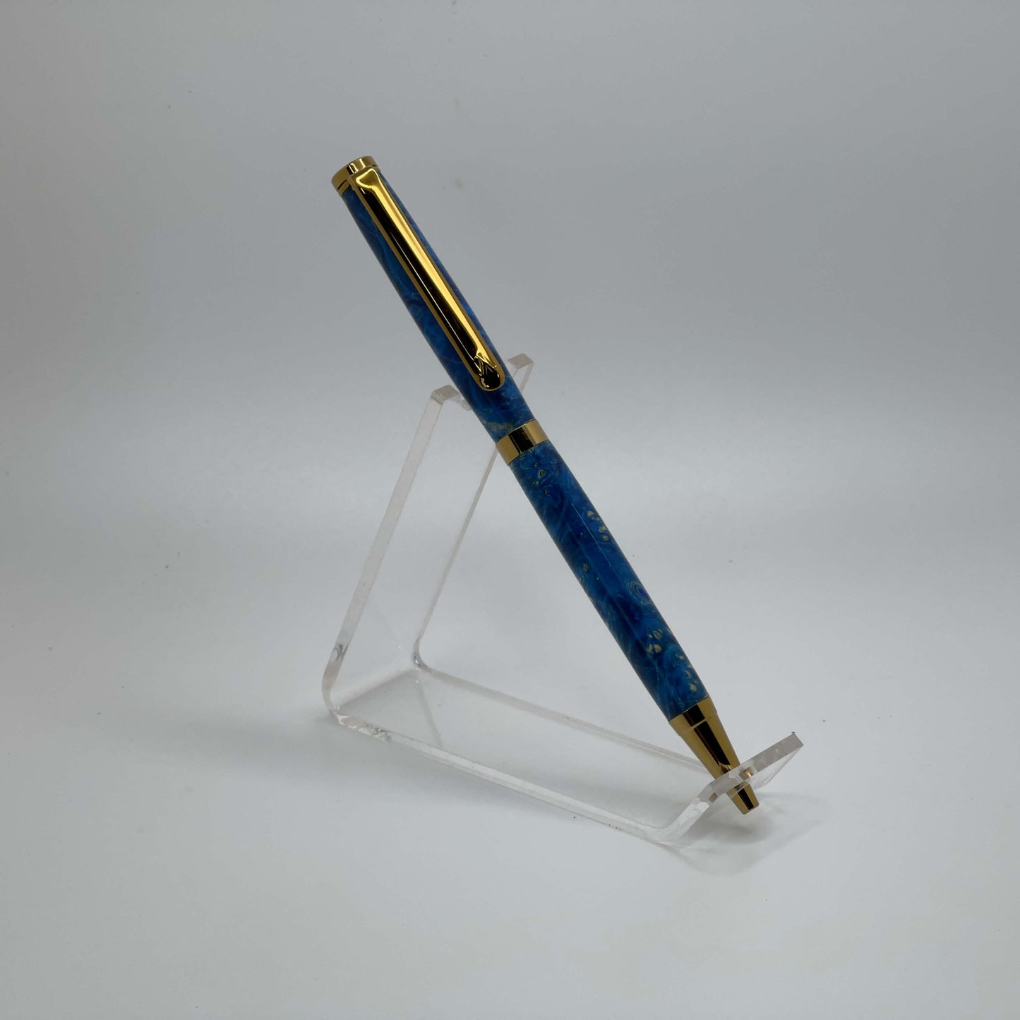 Left side view of handcrafted pen with Box Elder Burl wood dyed blue