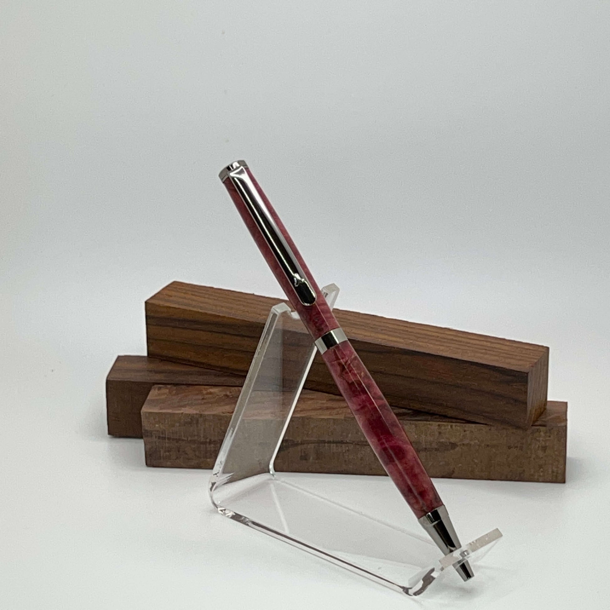 Handcrafted pen with Box Elder Burl wood dyed magenta and black titanium hardware